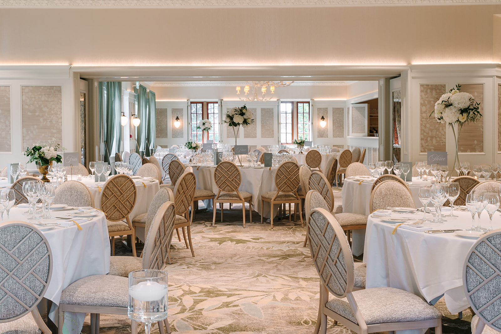 Image of the Parkview wedding suite at Pennyhill Park Hotel in Surrey with tables laid ready for a wedding breakfast.